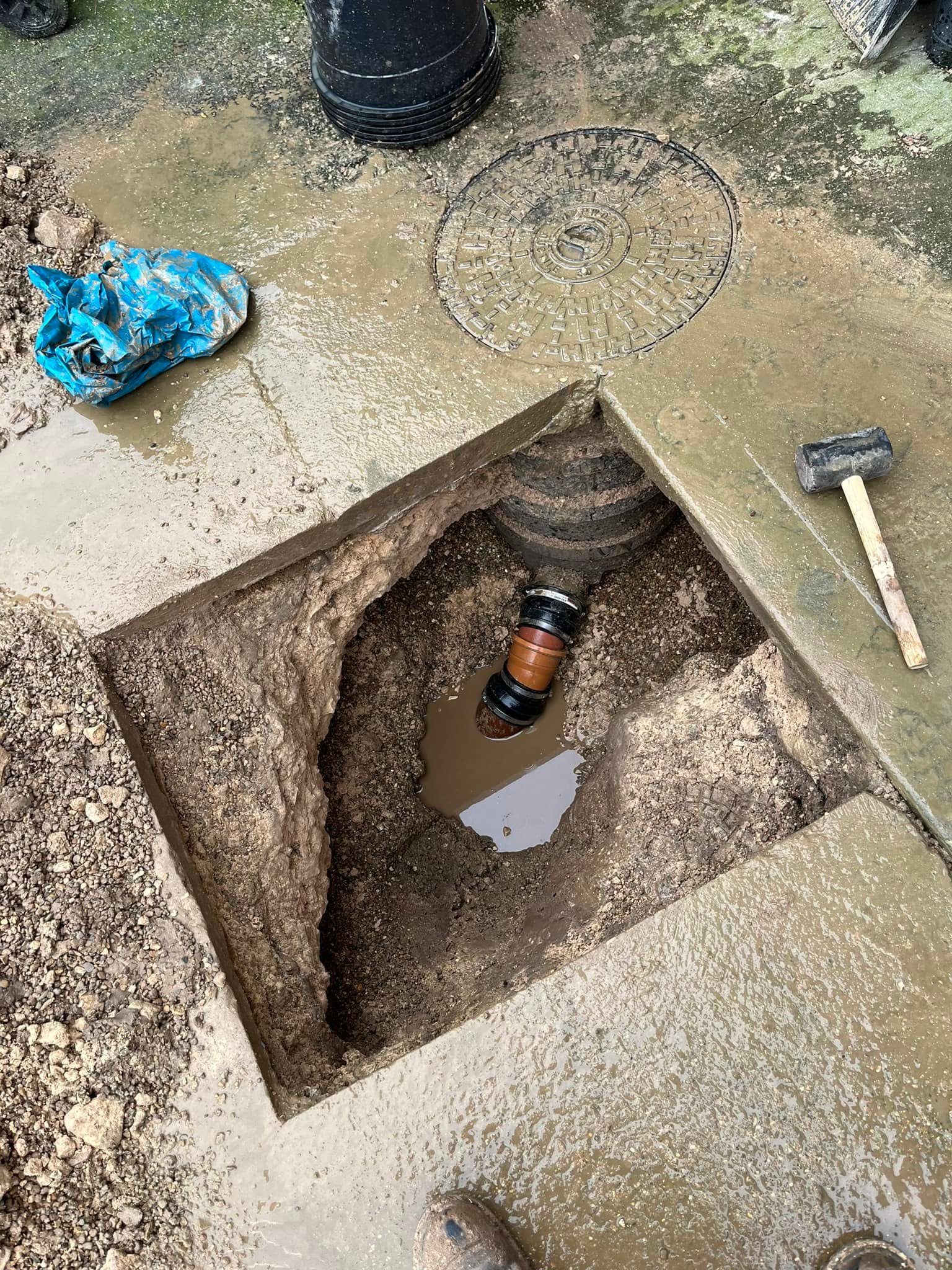 Excavated underground sewer connection during plumbing repair