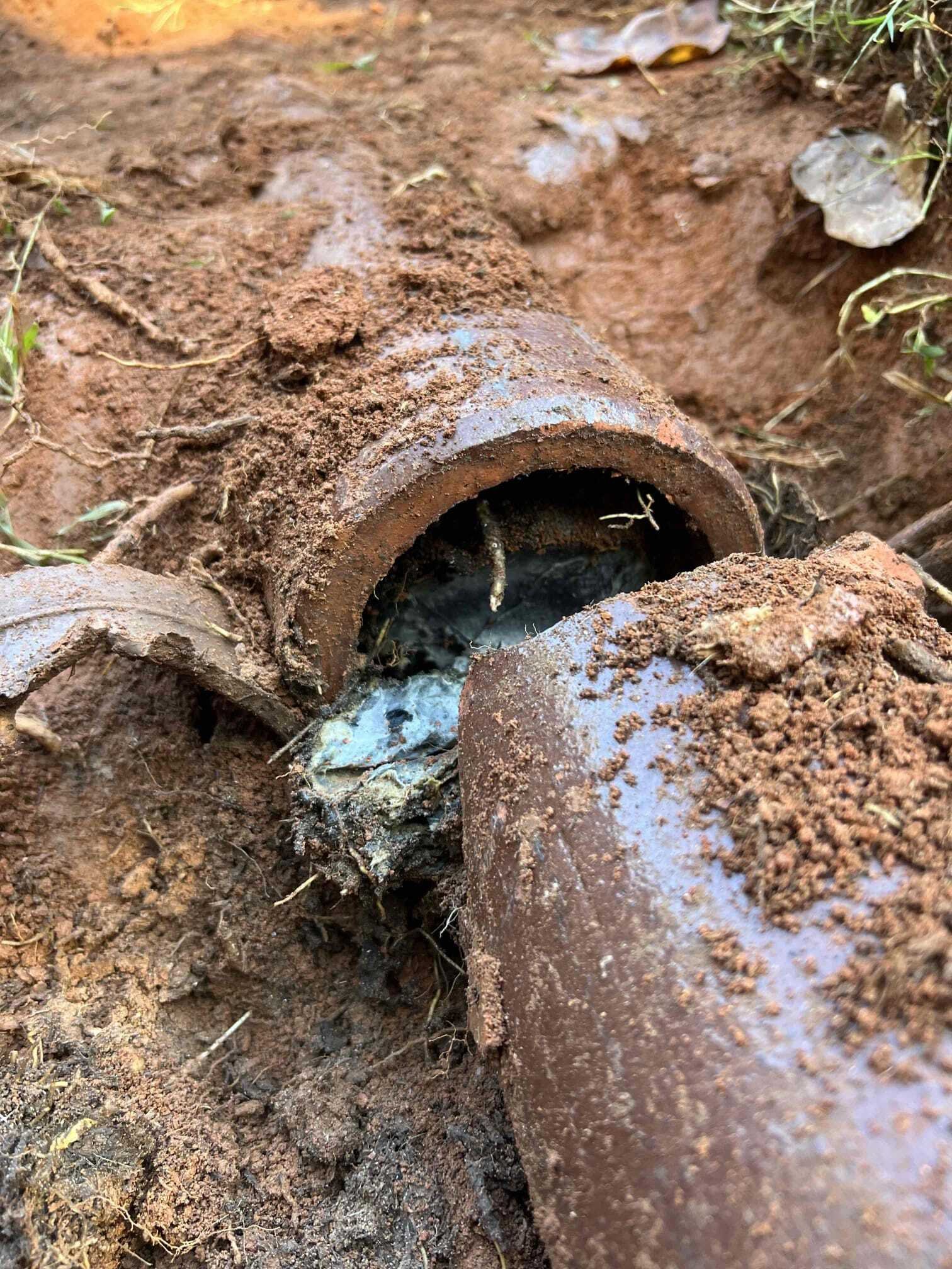 Broken underground pipe exposed during excavation